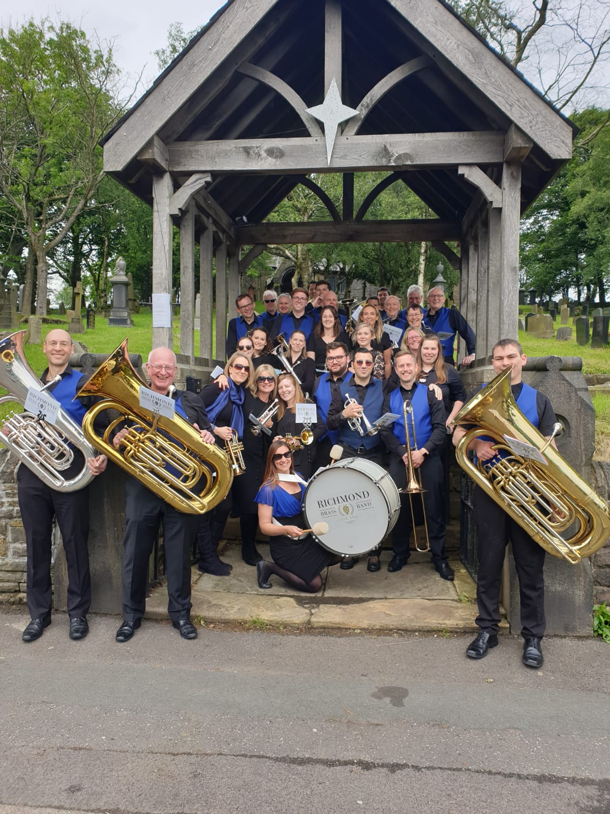 Richmond Brass Band under an arch in Denshaw